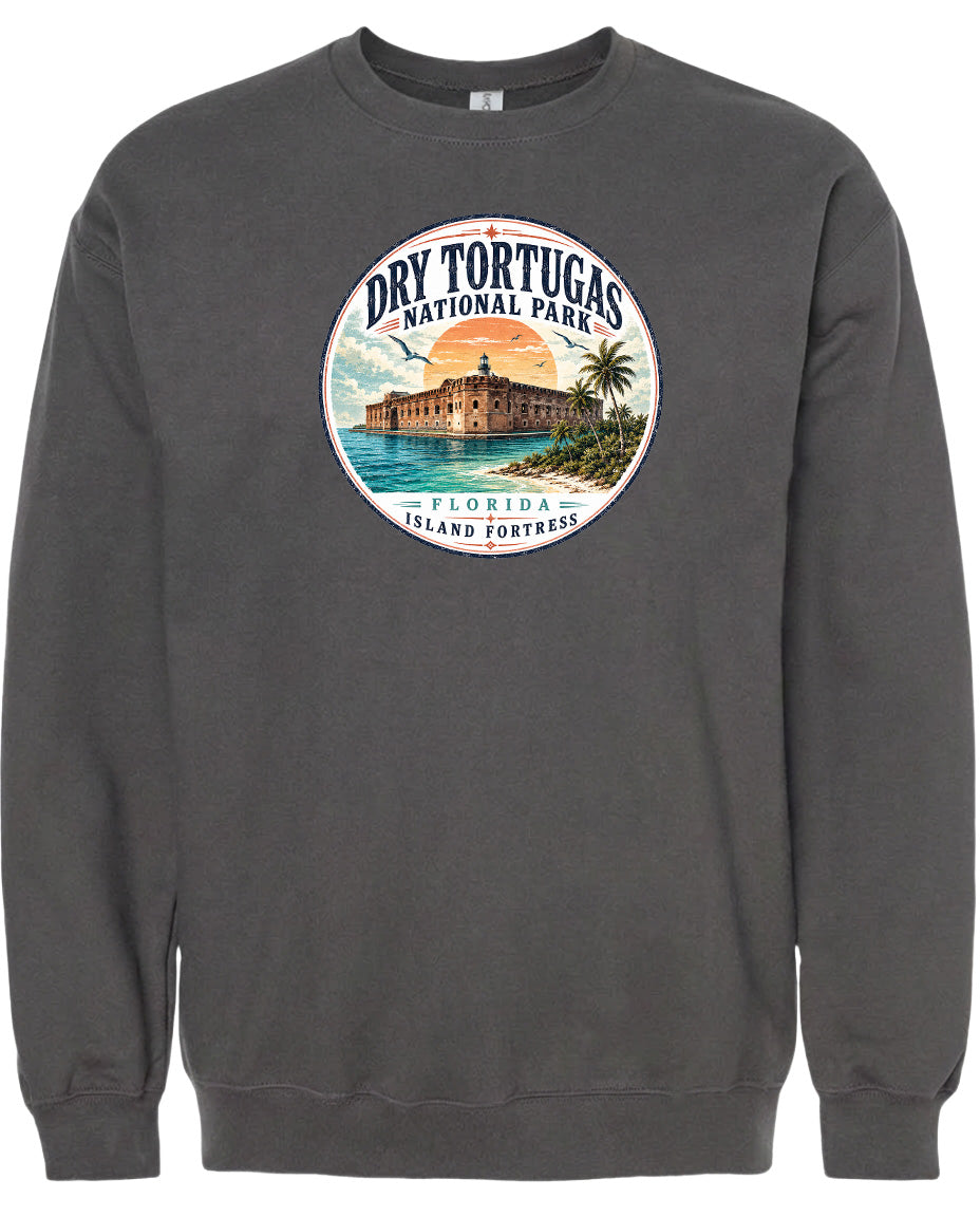 A gray sweatshirt with a circular graphic design featuring a building and palm trees, along with the text "Dry Tortugas National Park, Florida Island Fortresses".