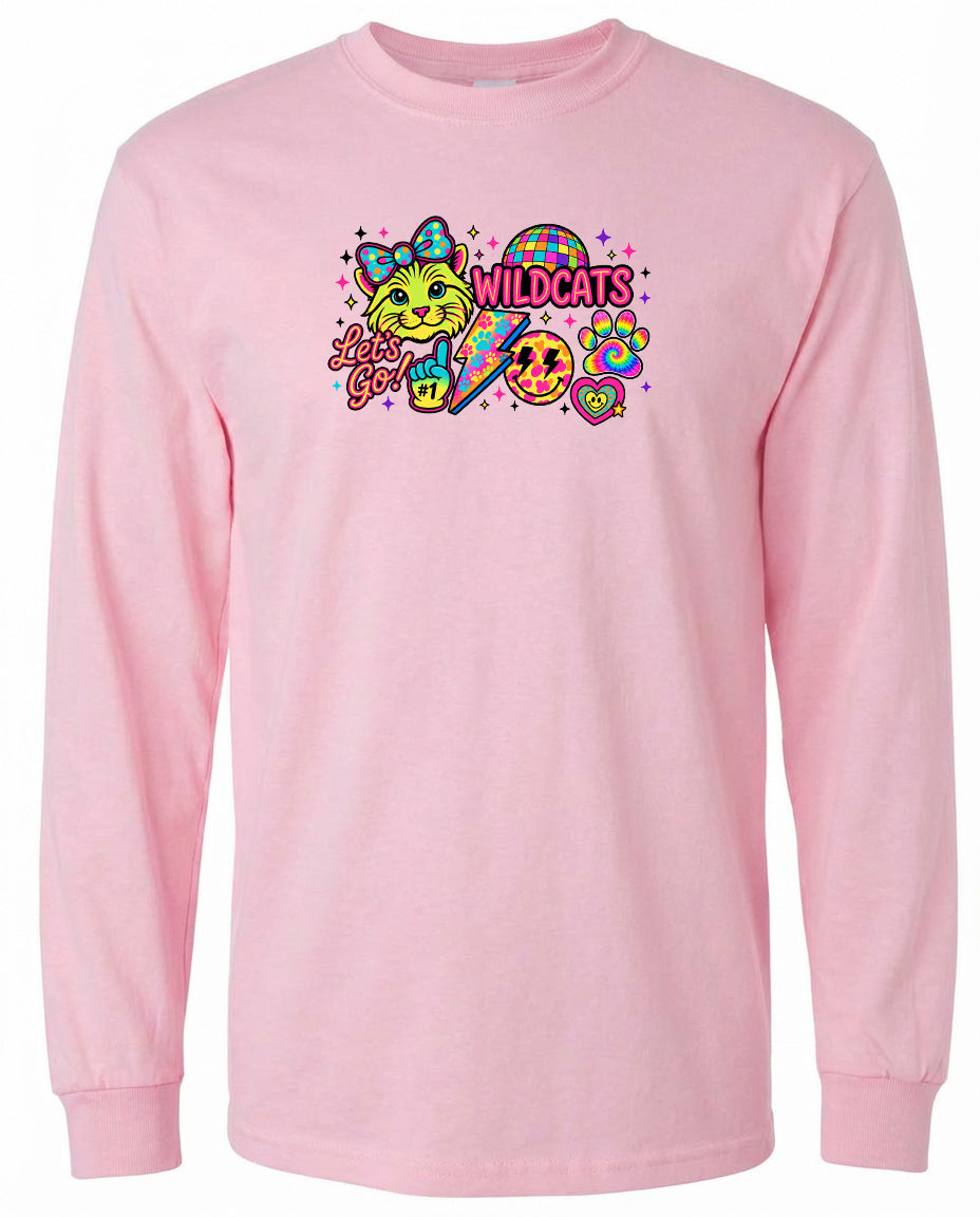 A pink long-sleeved t-shirt with a colorful graphic design featuring a cat, a rainbow, and the text "Wildcats" along with a smiley face.