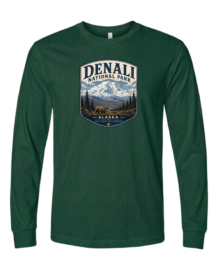 A green long-sleeved t-shirt with a graphic design depicting a mountain landscape and bears, along with the text "DENALI NATIONAL PARK ALASKA LAST GREAT WILDERNESS".
