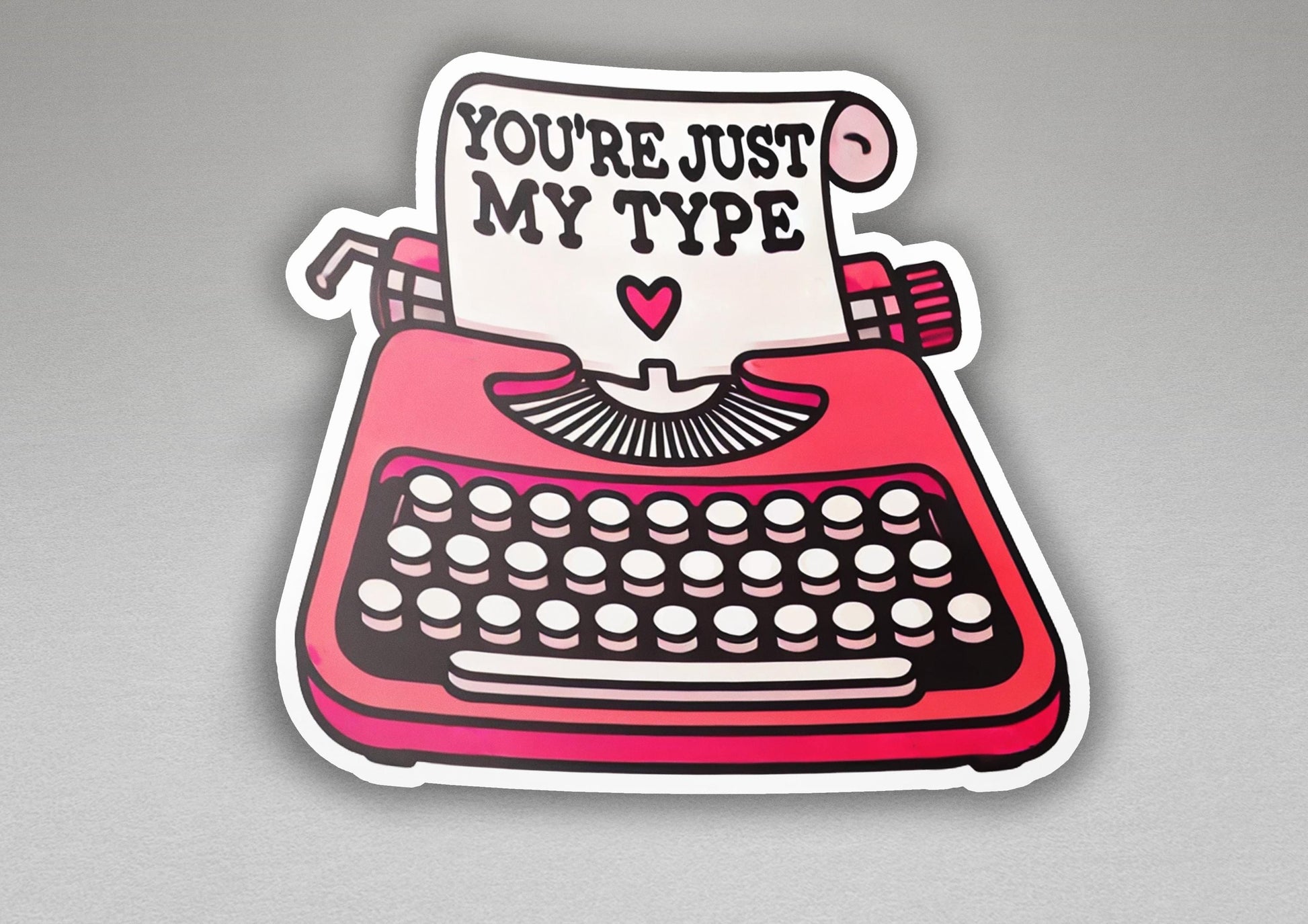 a sticker of a typewriter with a sign that says you're just