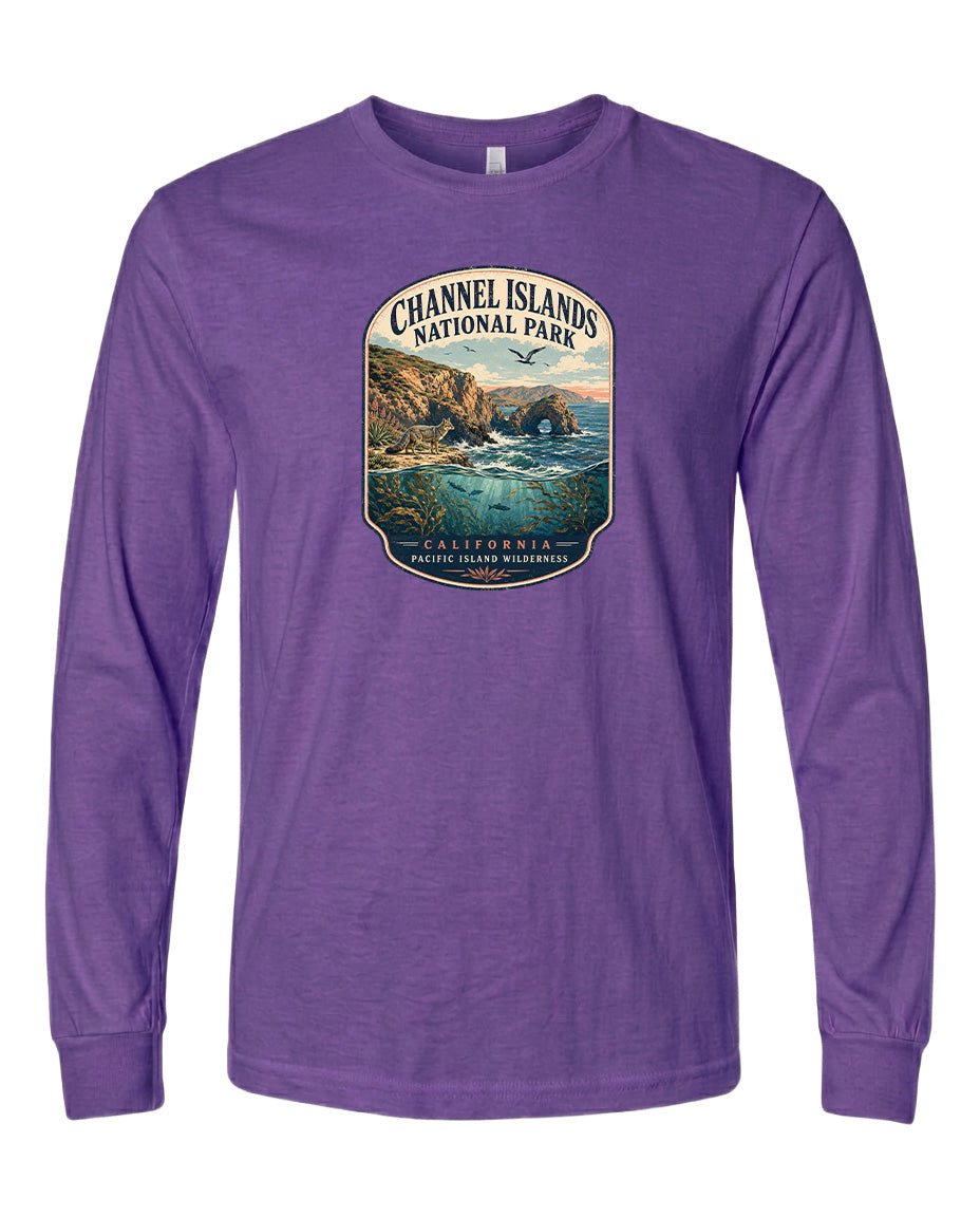 A purple long-sleeved t-shirt with a graphic design depicting a scenic coastal landscape, including cliffs, water, and a sunset.