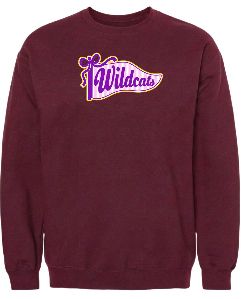 A burgundy-colored sweatshirt with a graphic design featuring the word "Wildcats" in purple and yellow colors.