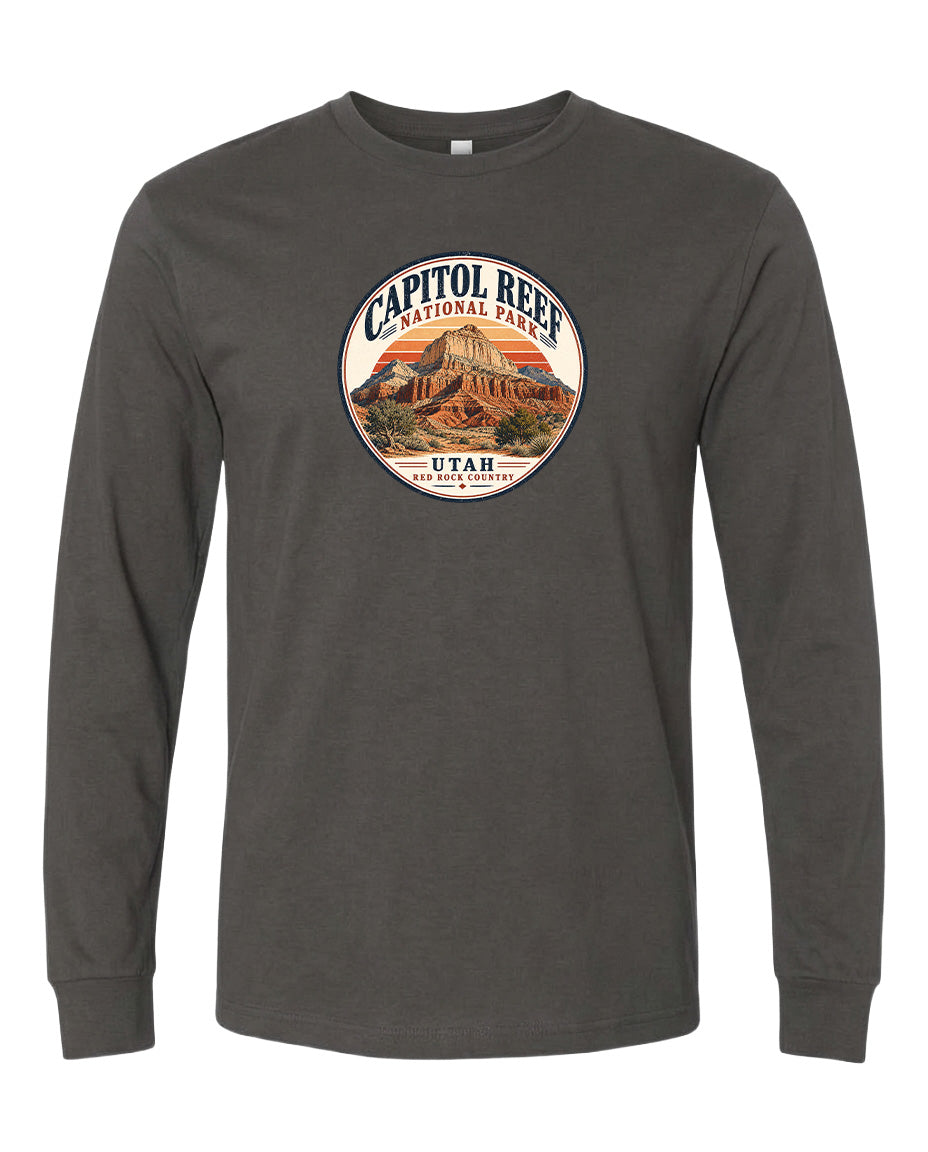 A gray long-sleeved t-shirt with a circular design featuring the Capitol Reef National Park logo and a mountain landscape.