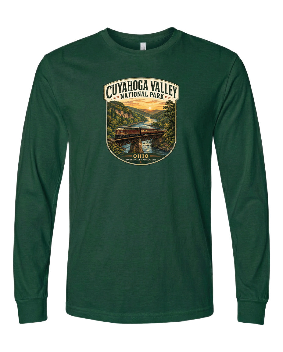 A green long-sleeved t-shirt with a graphic design depicting a scenic view of the Cuyahoga Valley National Park, featuring a bridge, trees, and a river.