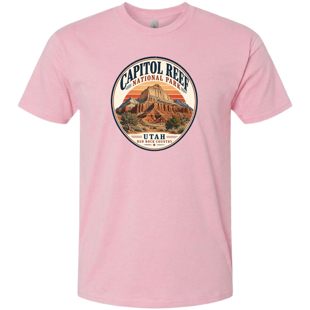 A pink t-shirt with a circular graphic design featuring the Capitol Reef National Park in Utah.