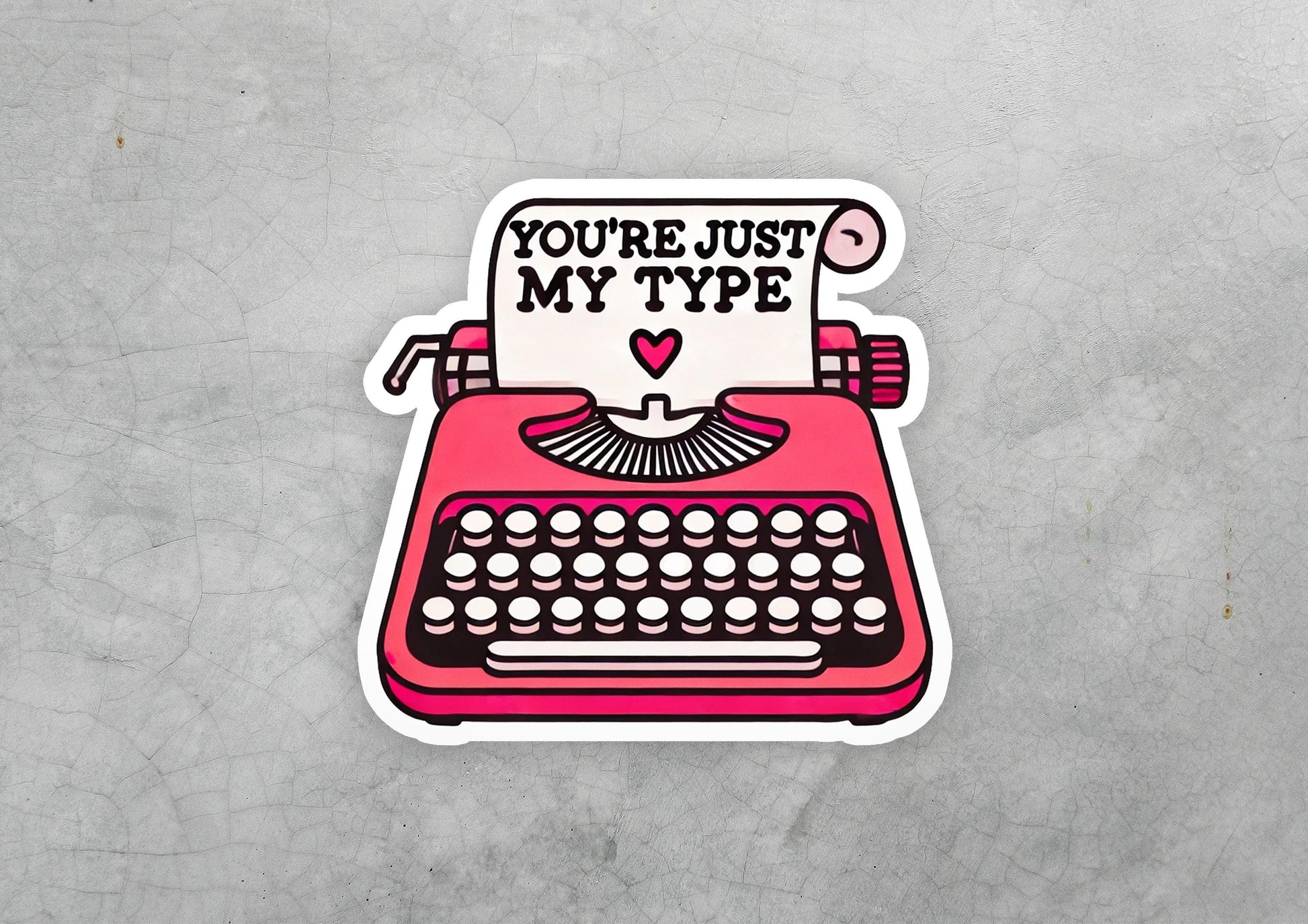 a sticker of a typewriter with the words you're just my type