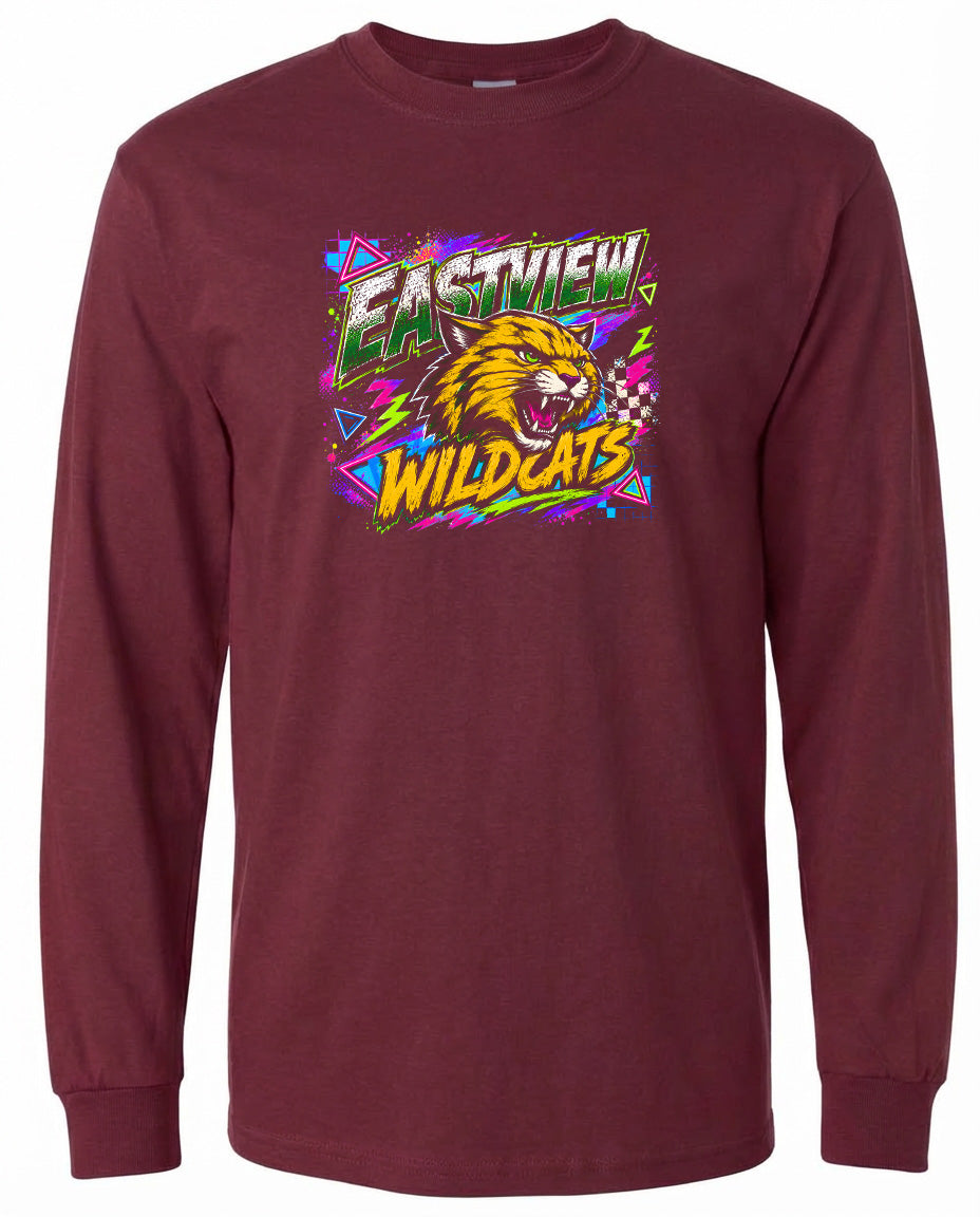 A burgundy long-sleeved t-shirt with a graphic design featuring a yellow and orange cat's head surrounded by colorful geometric shapes and the text "EASTVIEW WILDCATS".