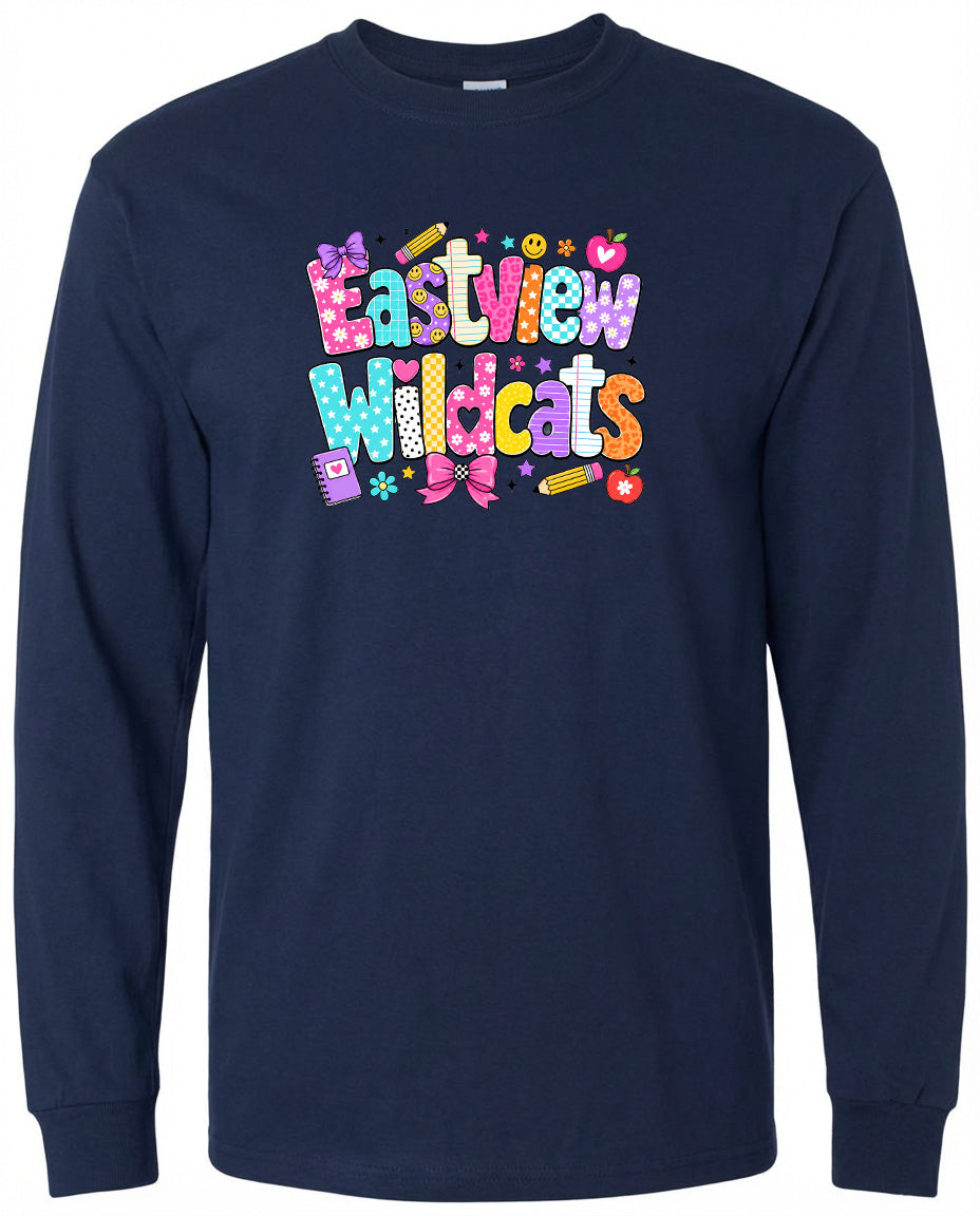 A navy blue long-sleeved shirt with a colorful graphic design featuring the text "Eastview Wildcats" and various decorative elements such as flowers, hearts, and pencils.