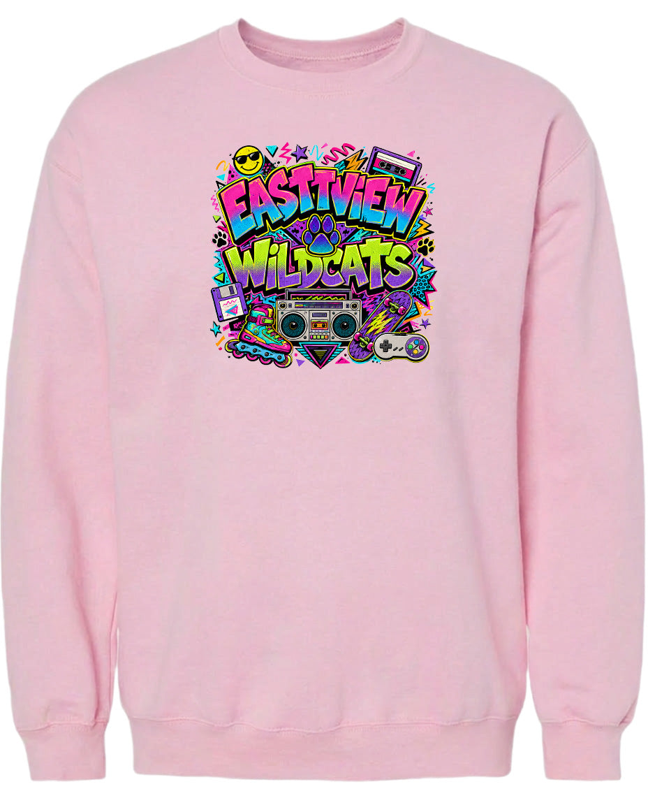 A pink sweatshirt with a colorful graphic design featuring the text "EASTVIEW WILDCATS" surrounded by various icons and symbols, such as a boombox, skateboard, and other retro-style elements.