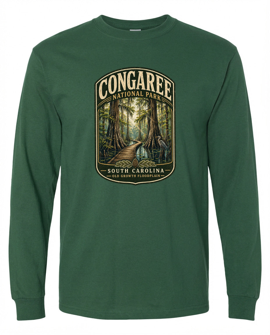 A green long-sleeved t-shirt with a graphic design depicting a forest scene, featuring a path leading through the trees.