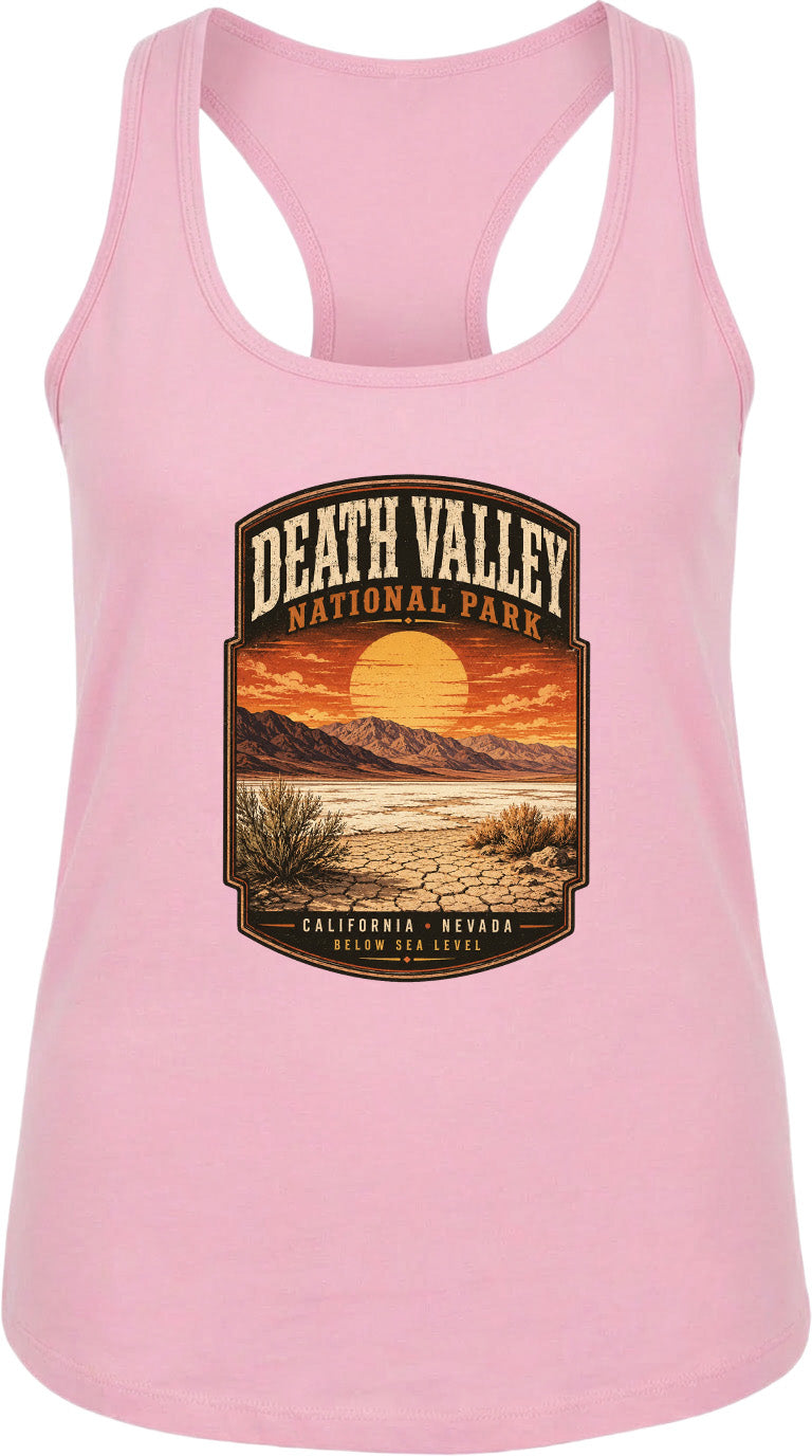 A pink tank top with a graphic design depicting Death Valley National Park, including a sunset over the desert landscape.