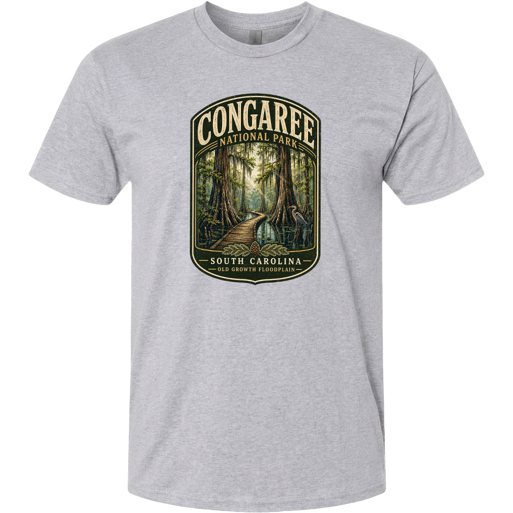 A gray t-shirt with a graphic design depicting a forest scene with a path leading through it, surrounded by trees and foliage.