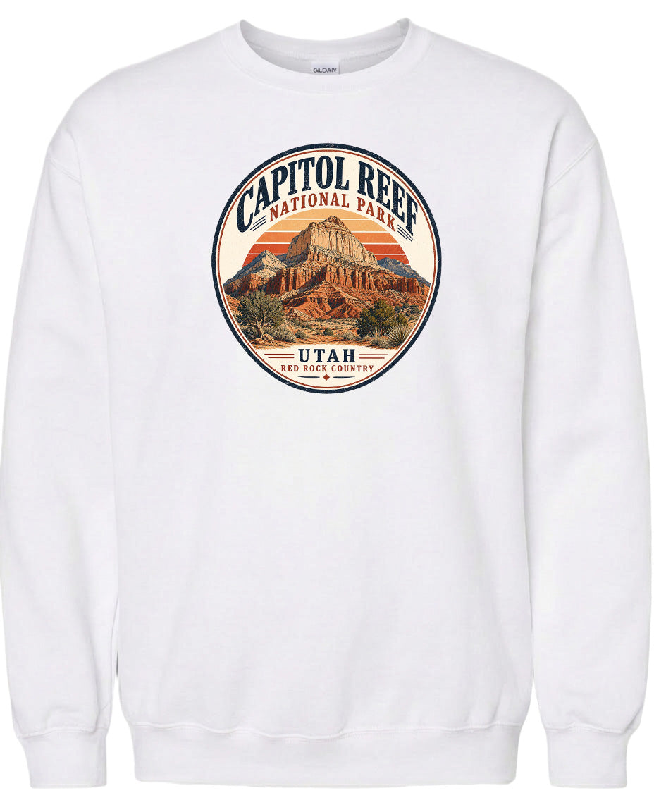 A white sweatshirt with a circular design featuring the Capitol Reef National Park in Utah.
