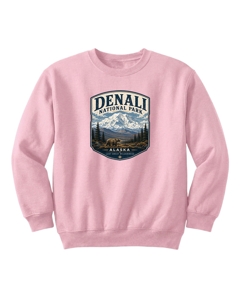 A pink sweatshirt with a graphic design featuring a mountain landscape and bears, representing Denali National Park in Alaska.