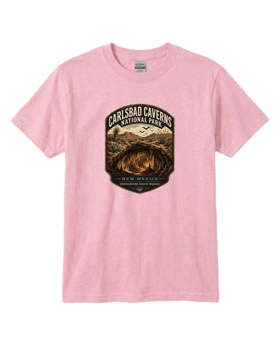 A pink t-shirt with a graphic design depicting the entrance to the Carlsbad Caverns National Park in New Mexico.