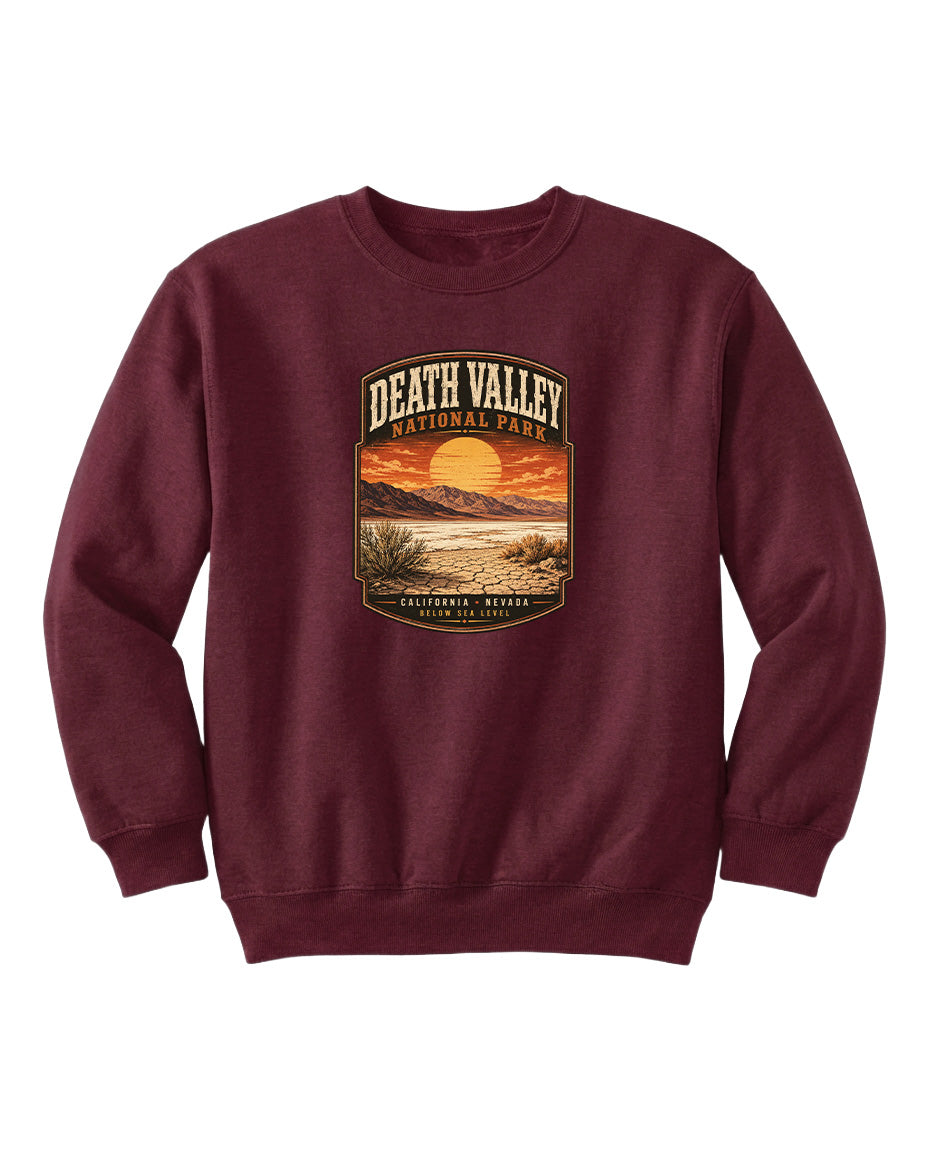 A burgundy sweatshirt with a graphic design depicting a sunset over Death Valley National Park, California, Nevada.