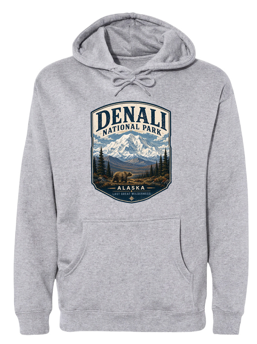 A gray hoodie with a graphic design featuring a mountain landscape and a bear, along with the text "DENALI NATIONAL PARK ALASKA LAST GREAT WILDERNESS".