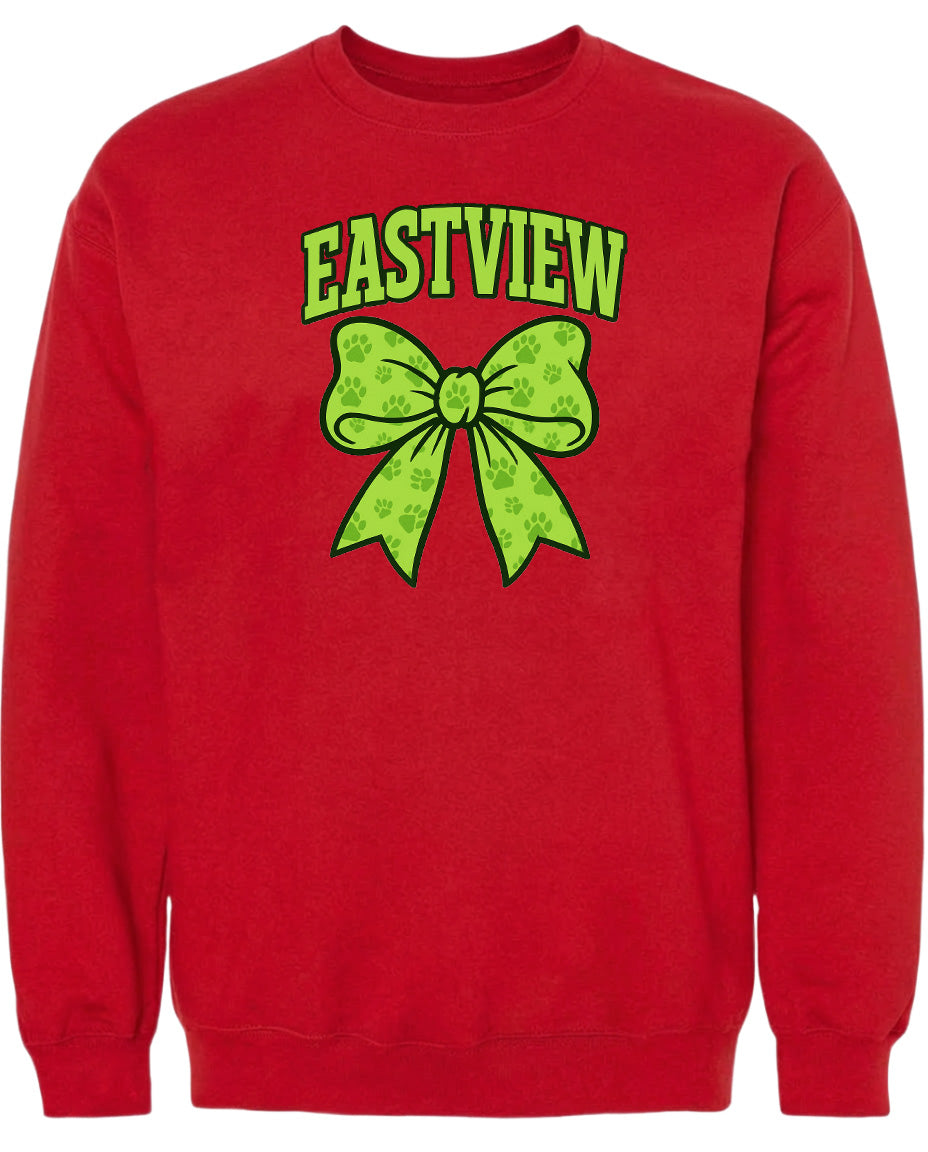 A red sweatshirt with a green bow and paw prints on it.