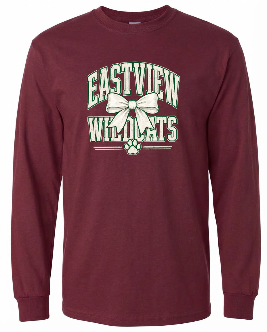 A burgundy long-sleeved t-shirt with a graphic design featuring the text "EASTVIEW WILDCATS" and a white bow.