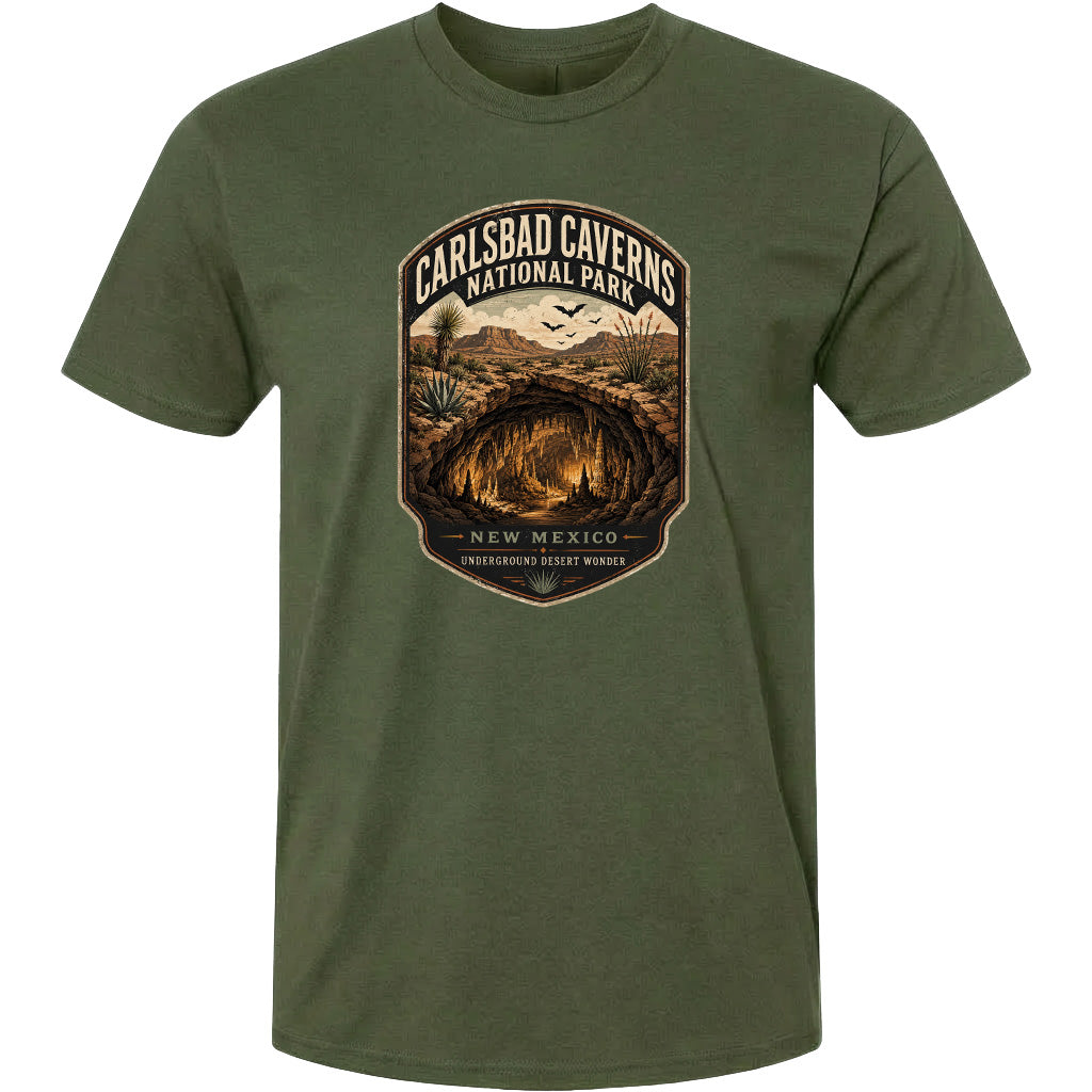 A green t-shirt with a graphic design depicting the Carlsbad Caves National Park in New Mexico, featuring a cave system and desert landscape.