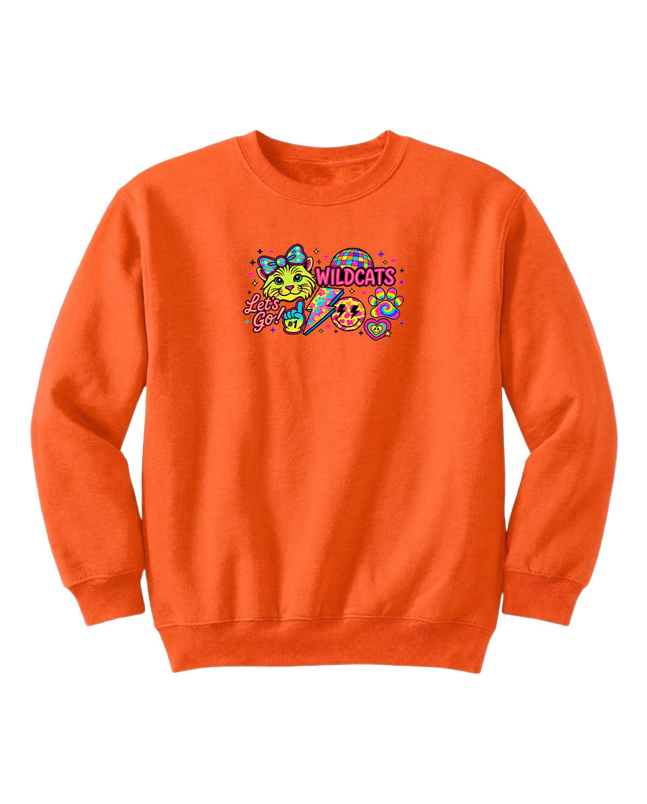 An orange sweatshirt with a colorful graphic design featuring a smiling face, a bow, and the text "WILDCATS" printed on it.