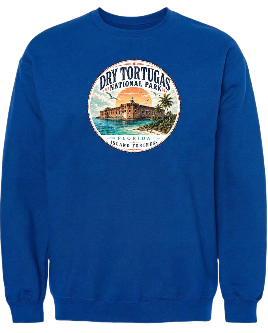 A blue sweatshirt with a circular graphic design featuring a building and palm trees, along with the text "Dry Tortugas National Park, Florida Island Fortress".