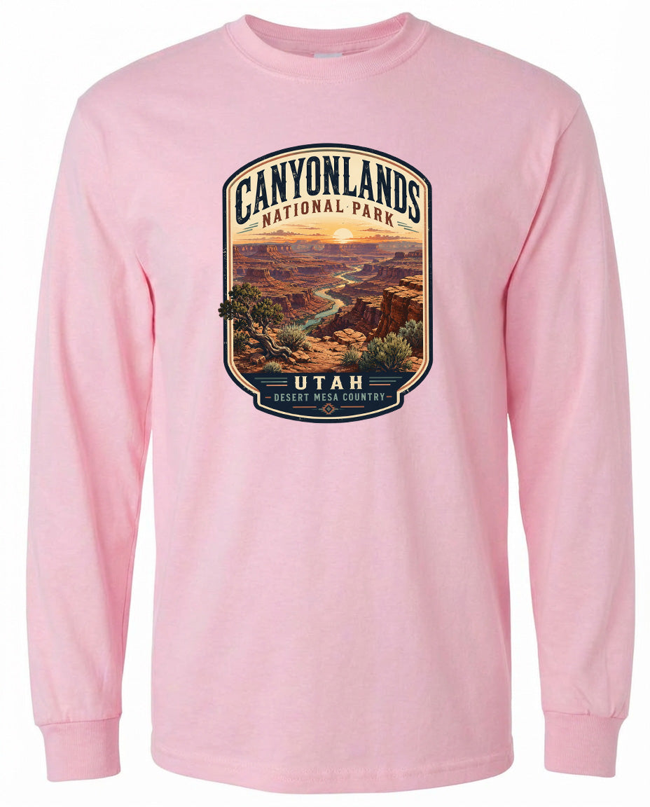 A pink long-sleeved t-shirt with a graphic design depicting the Canyonlands National Park in Utah, USA.