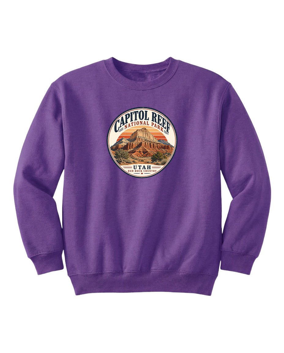 A purple sweatshirt with a circular design featuring the Capitol Reef National Park logo and the text "UTAH" printed on it.