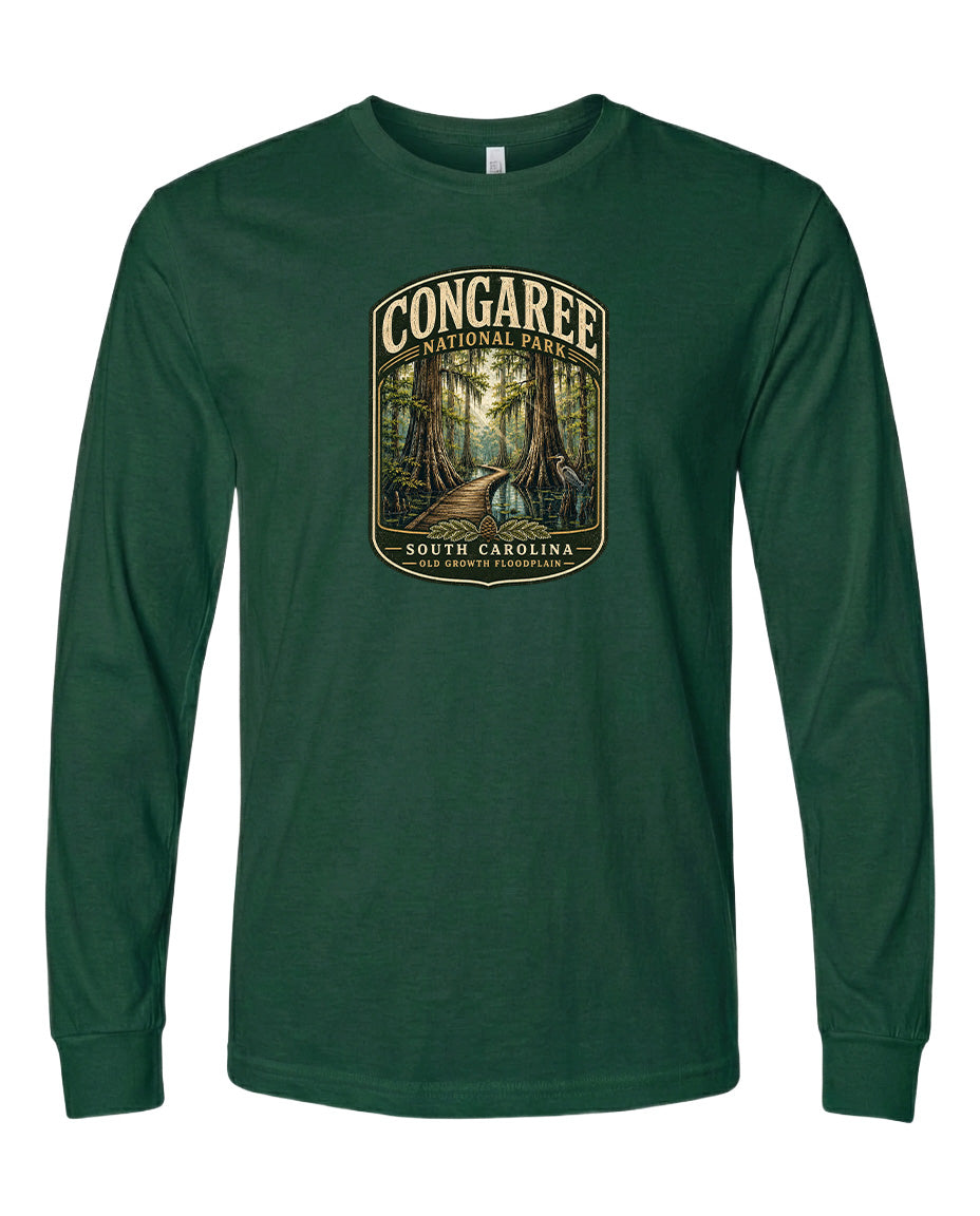A green long-sleeved t-shirt with a graphic design depicting a forest scene, featuring a path leading through the trees.