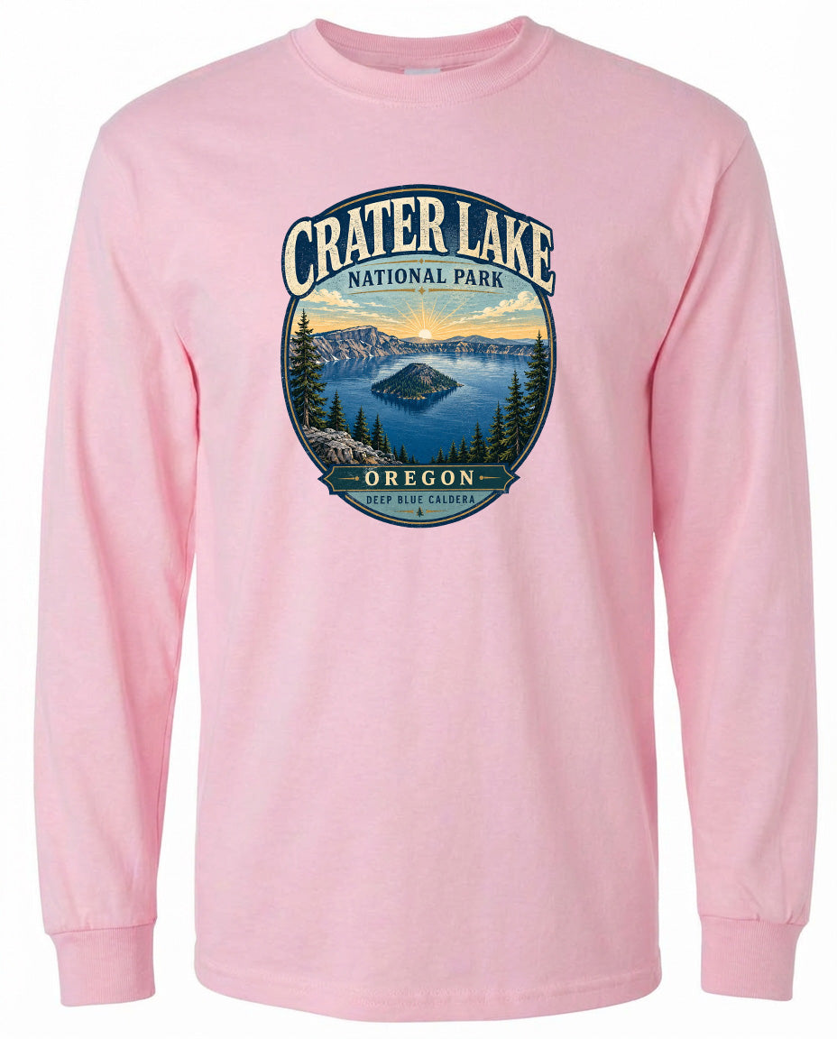 A pink long-sleeved t-shirt with a graphic design depicting Crater Lake National Park in Oregon.