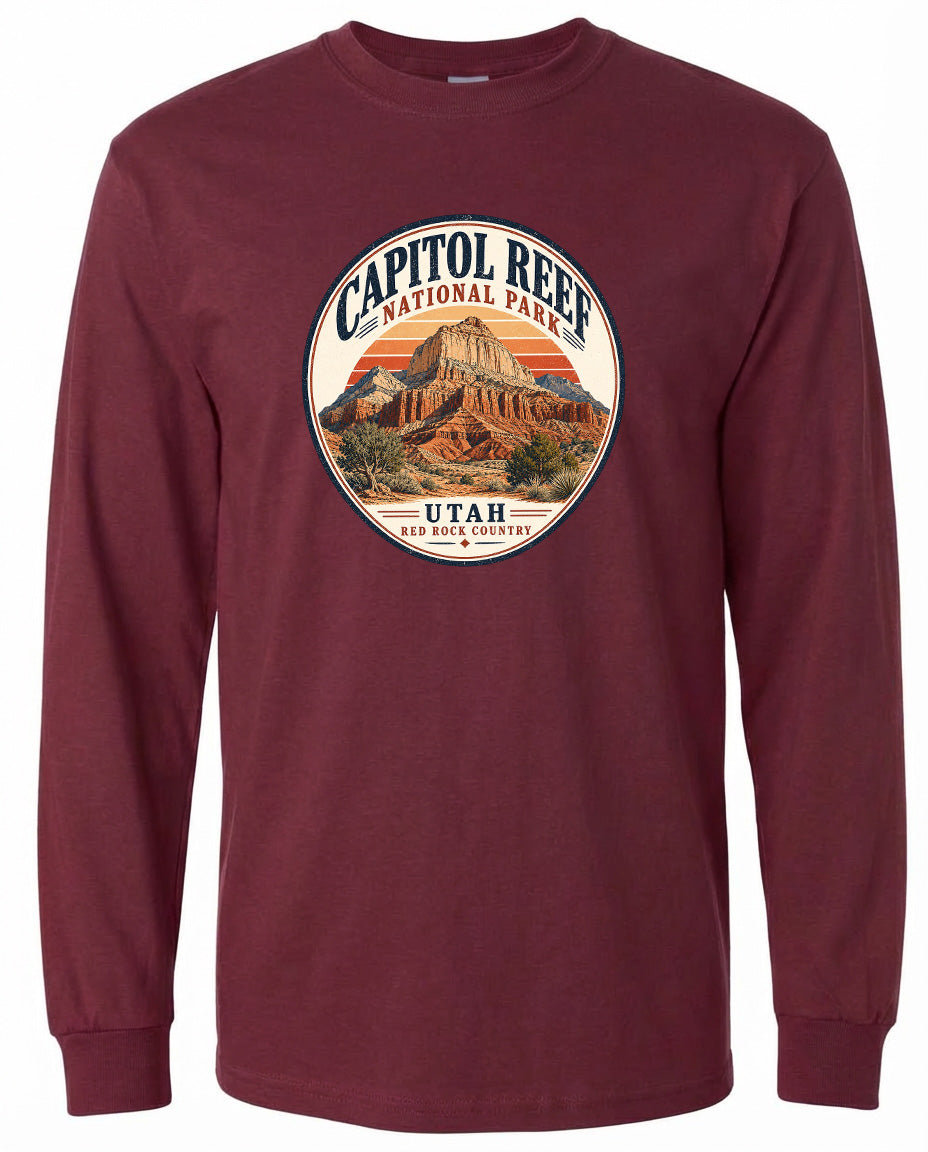 A long-sleeved burgundy t-shirt with a circular design featuring the Capitol Reef National Park in Utah.