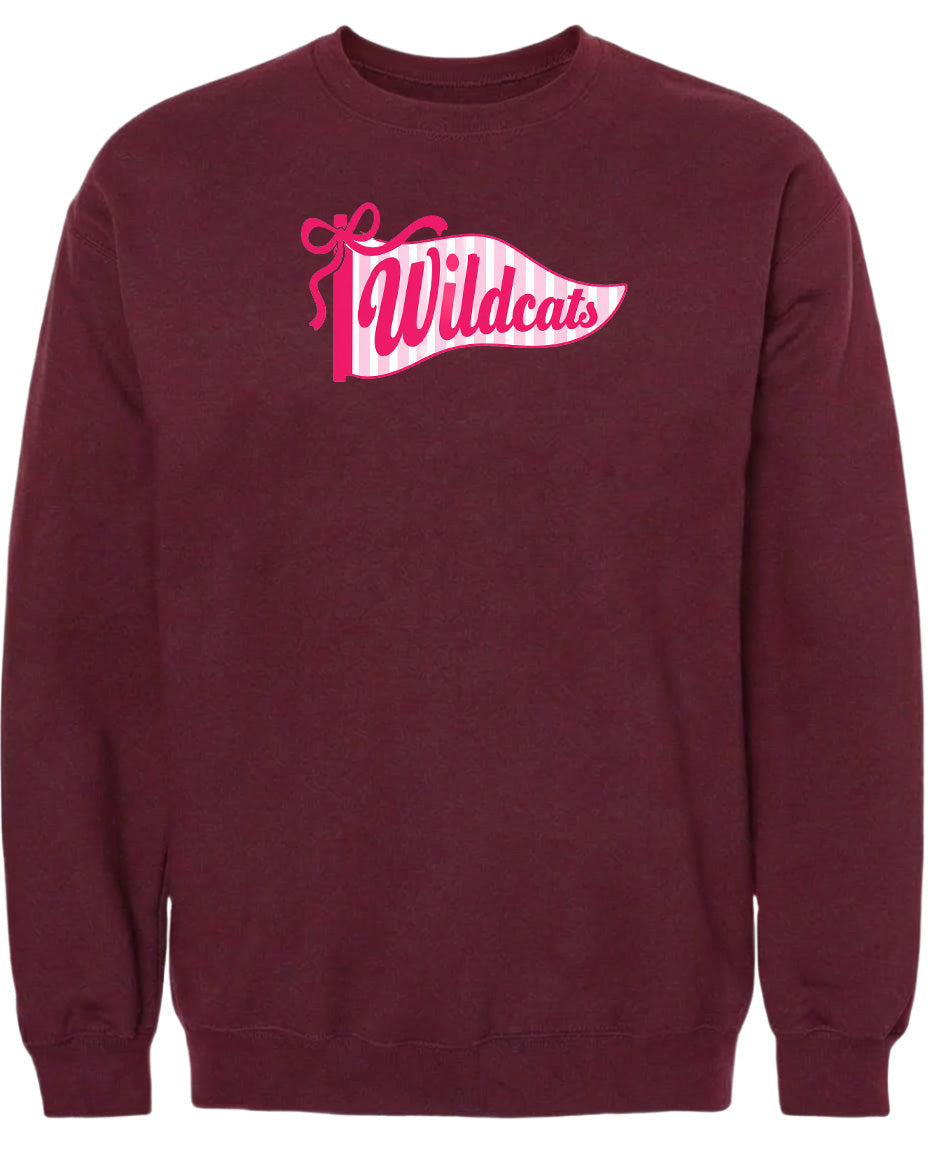 A burgundy sweatshirt with a pink and white banner design featuring the word "Wildcats" on it.