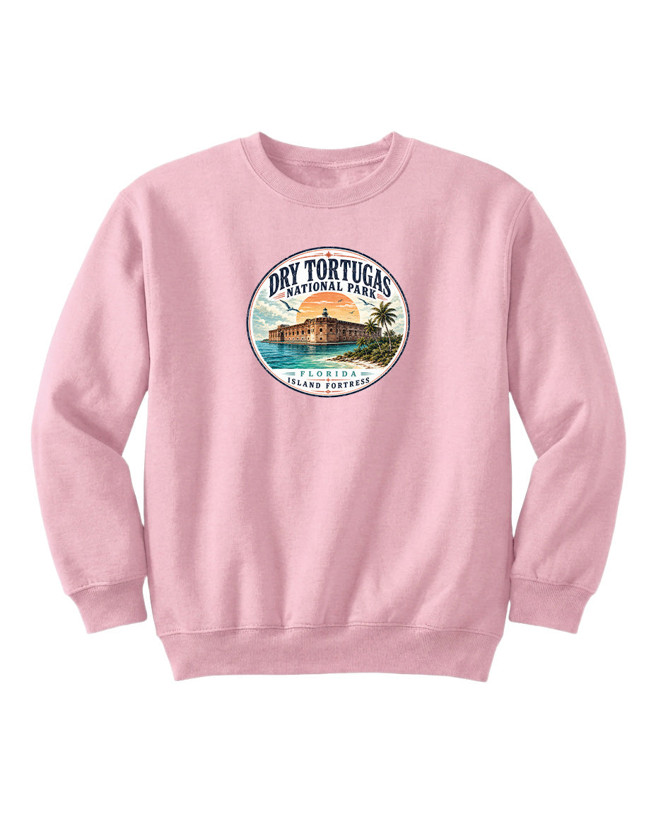 A pink sweatshirt with a circular graphic design featuring a beach scene and a building, likely representing Dry Tortugas National Park in Florida.