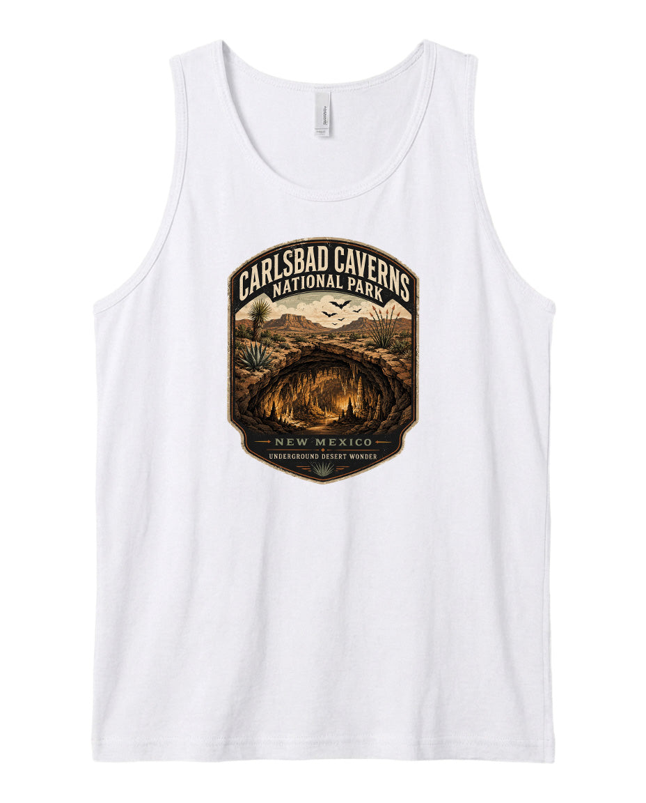 A white tank top with a graphic design featuring a desert landscape and the text "CARLSBAD CAVENS NATIONAL PARK NEW MEXICO UNDERGROUND WONDERER".