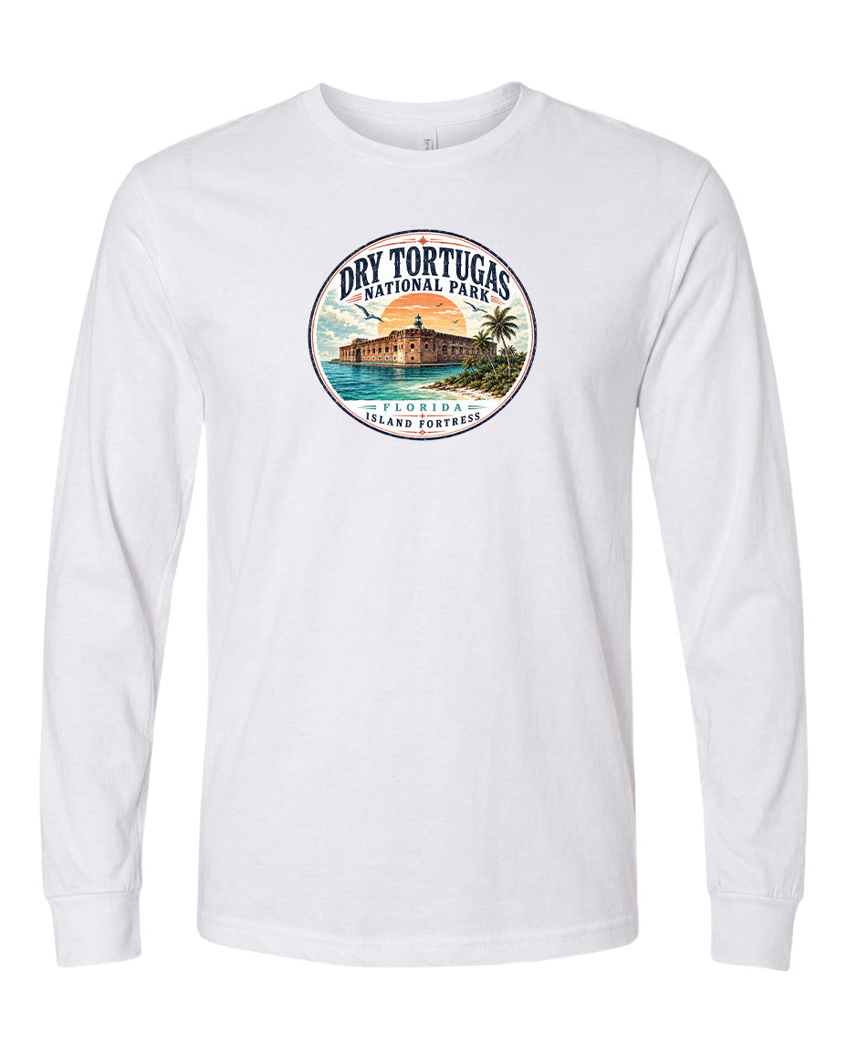 A white long-sleeved t-shirt with a circular graphic design featuring a tropical island landscape with palm trees and a building.