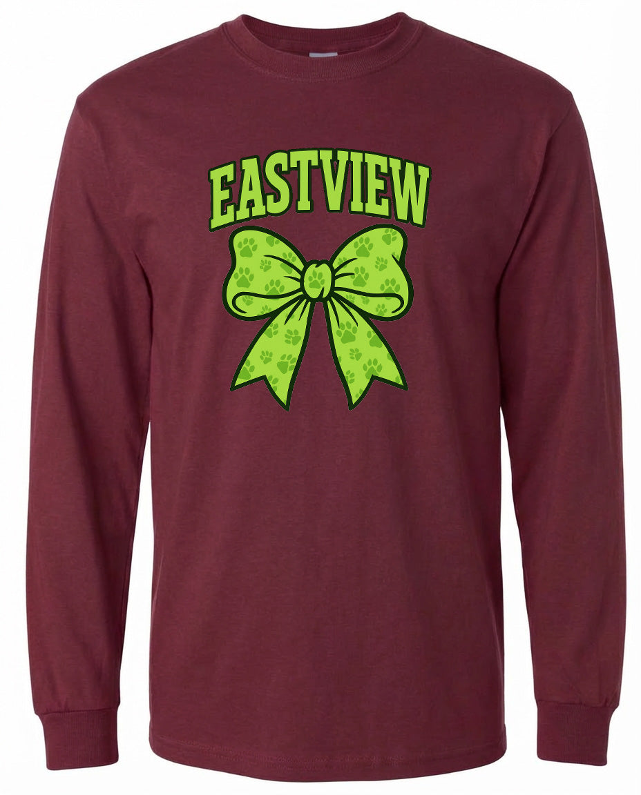 A burgundy long-sleeved t-shirt with a graphic design featuring a green bow and paw prints.