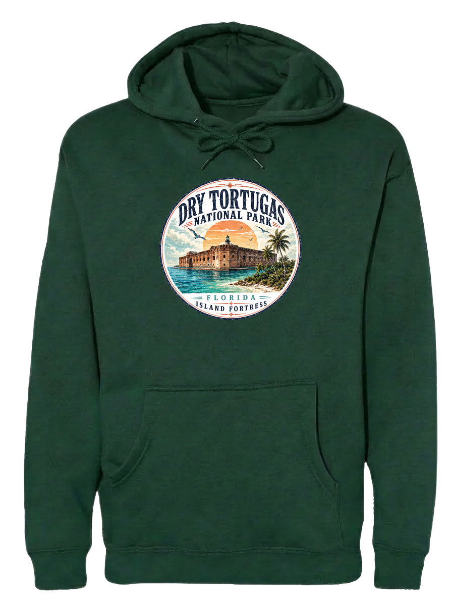 A green hoodie with a circular emblem featuring a tropical island with a castle, surrounded by palm trees and a sunset.