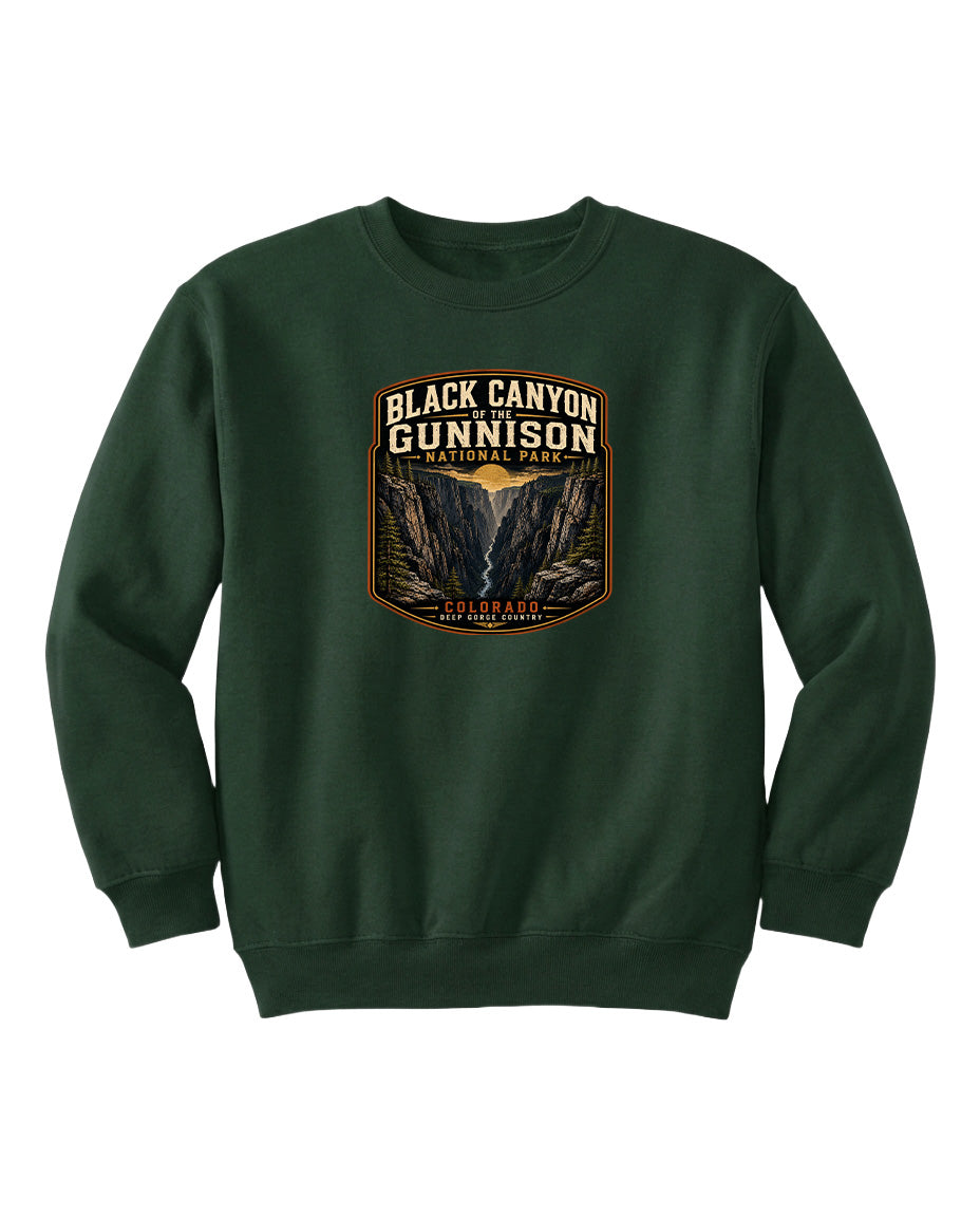 A green sweatshirt with a graphic design featuring the text "Black Canyon Gunnison National Park" and an illustration of a canyon.