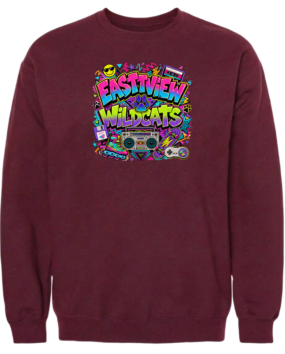 A burgundy sweatshirt with a colorful graphic design featuring the text "EASTVIEW WILDCATS" surrounded by various icons and elements, such as a boombox, a skateboard, and a peace sign.