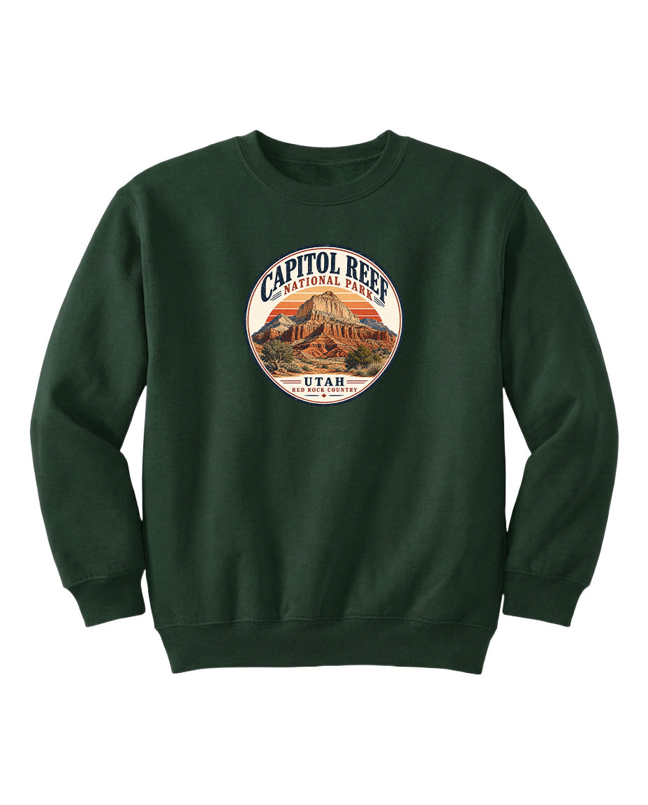A dark green sweatshirt with a circular logo that says "CAPITOL REEF NATIONAL PARK UTAH" and features an illustration of a mountain.