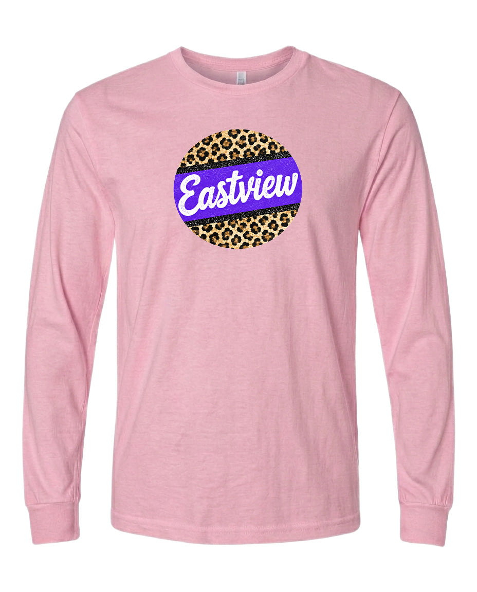 A pink long-sleeved t-shirt with a graphic design on the front. The design consists of a circular shape with a leopard print pattern, and the word "Eastview" written in a stylized font inside the circle.