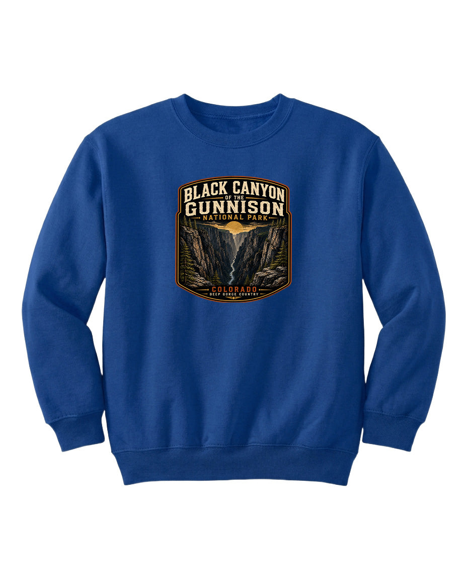 A blue sweatshirt with a graphic design featuring the text "Black Canyon Gunnison National Park" and an illustration of a canyon.