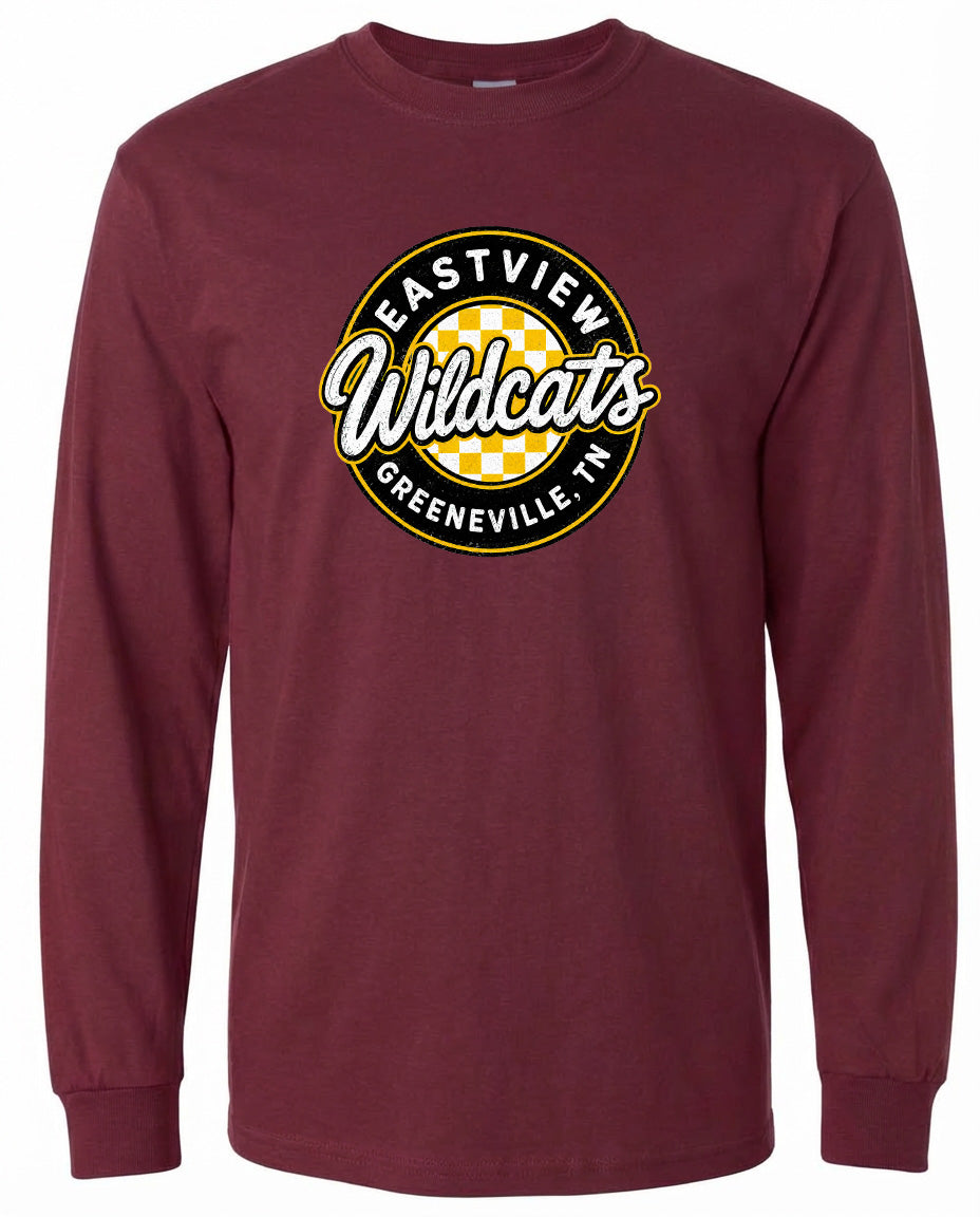 A burgundy long-sleeved t-shirt with a circular logo on the front. The logo features the text "EASTVIEW Wildcats" in a stylized font, surrounded by a yellow and black checkered pattern.