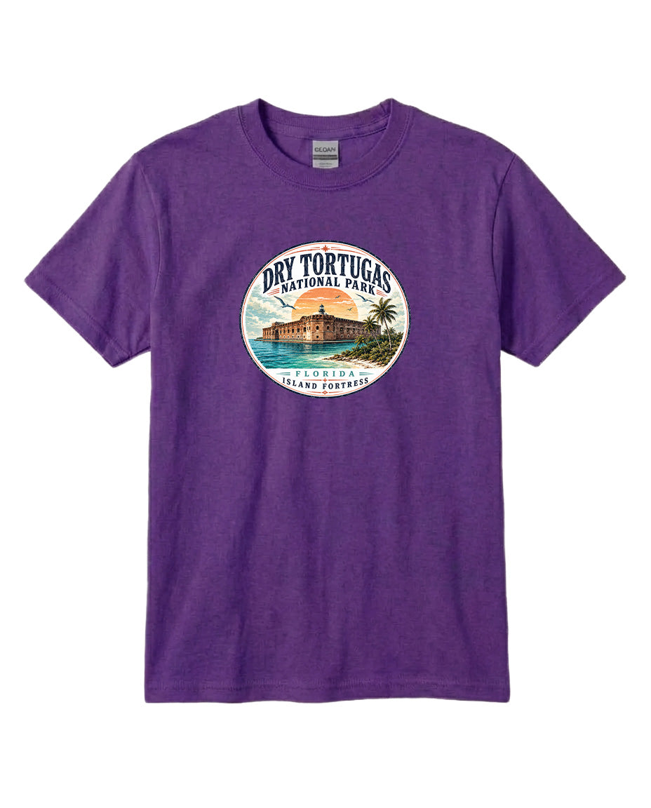 A purple t-shirt with a circular graphic design featuring a beach scene and a building, representing Dry Tortugas National Park in Florida.