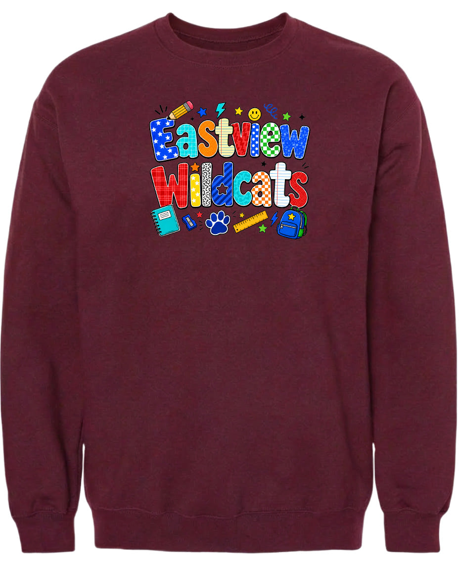 A burgundy sweatshirt with a colorful graphic design featuring the text "Eastview Wildcats" and various school-related icons such as a pencil, backpack, and calculator.