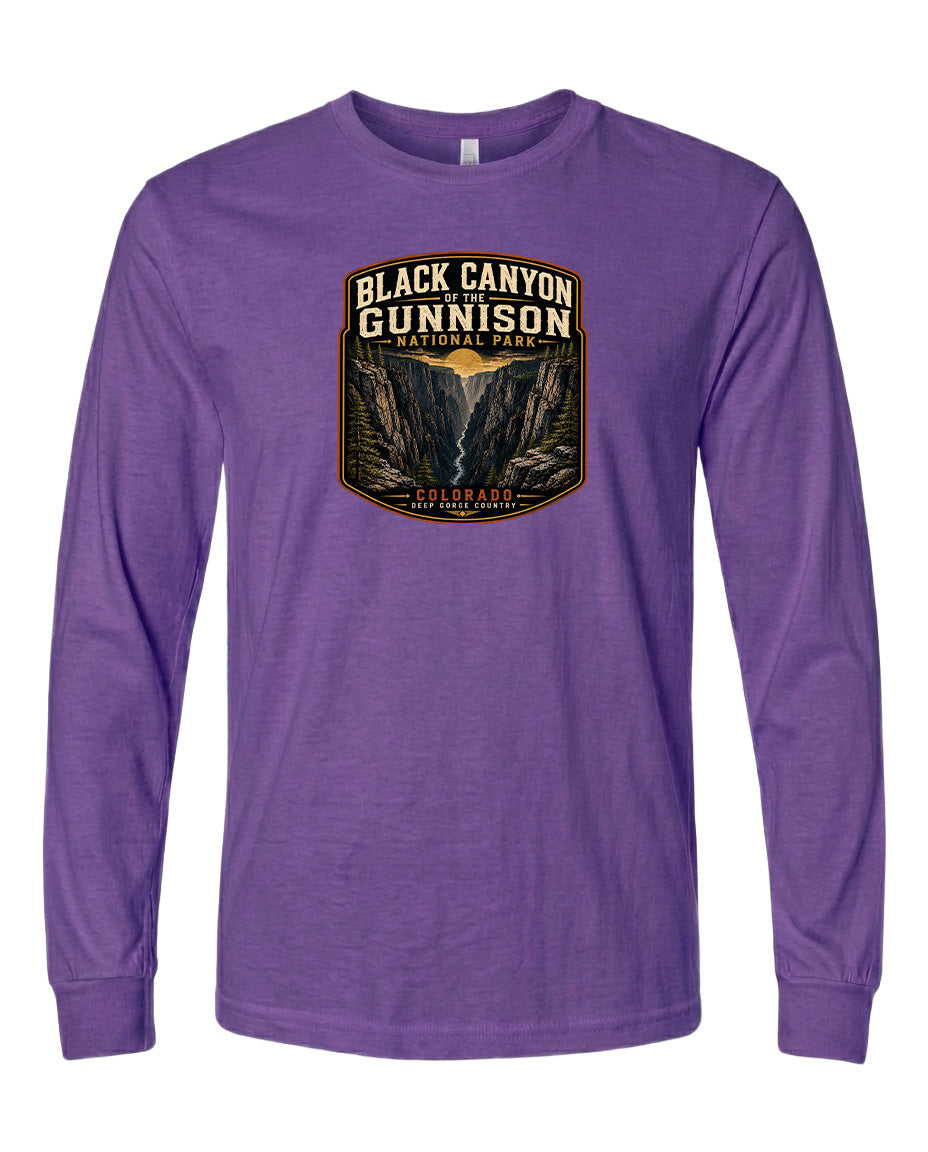 A purple long-sleeved t-shirt with a graphic design depicting the Black Canyon of the Gunnison National Park.