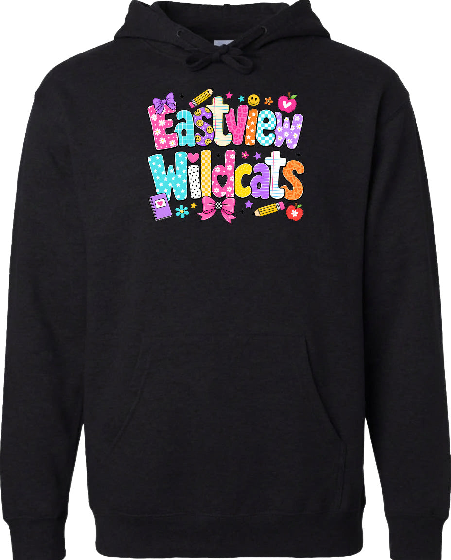 A black hoodie with a colorful, playful design featuring the text "Eastview Wildcats" and various decorative elements such as hearts, stars, and pencils.