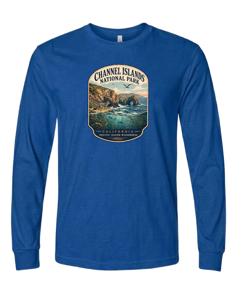 A blue long-sleeved t-shirt with a graphic design depicting a scenic coastal landscape, including cliffs, water, and a sunset.