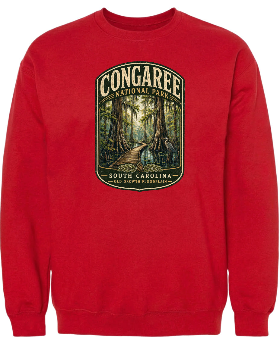 A red sweatshirt with a graphic design depicting a forest scene with a path leading through it.