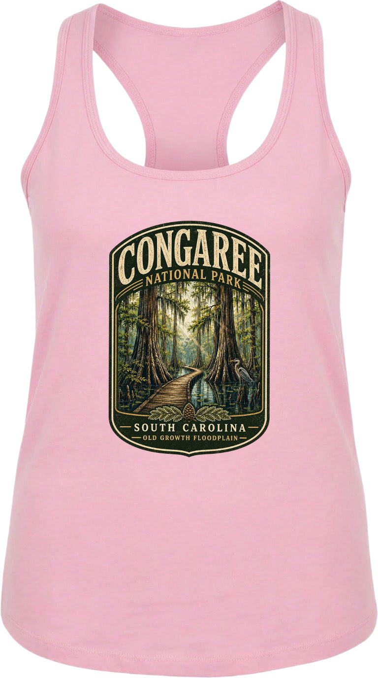 A pink tank top with a graphic design depicting a forest scene and a path leading through it, along with the text "CONGAREE NATIONAL PARK SOUTH CAROLINA OLD GROWTH FLOODPLAIN".